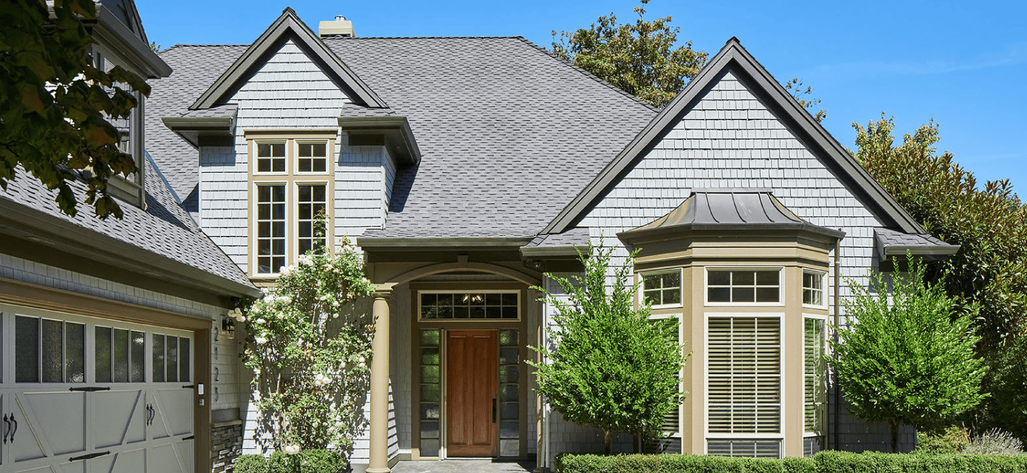Home with bay windows to the right of the front entrance.
