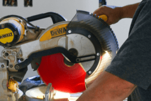 Person using a DeWalt chop saw.